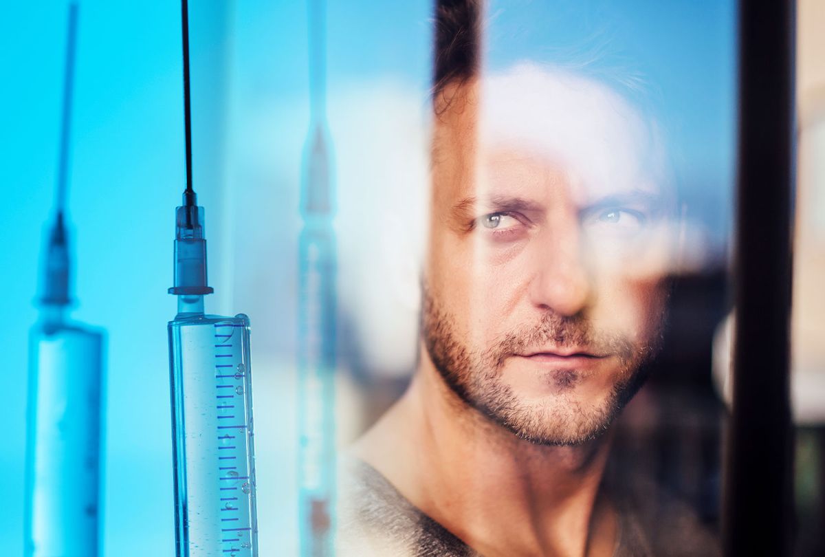 Close-up of man looking through window seen through glass | Vaccines (Photo illustration by Salon/Getty Images)