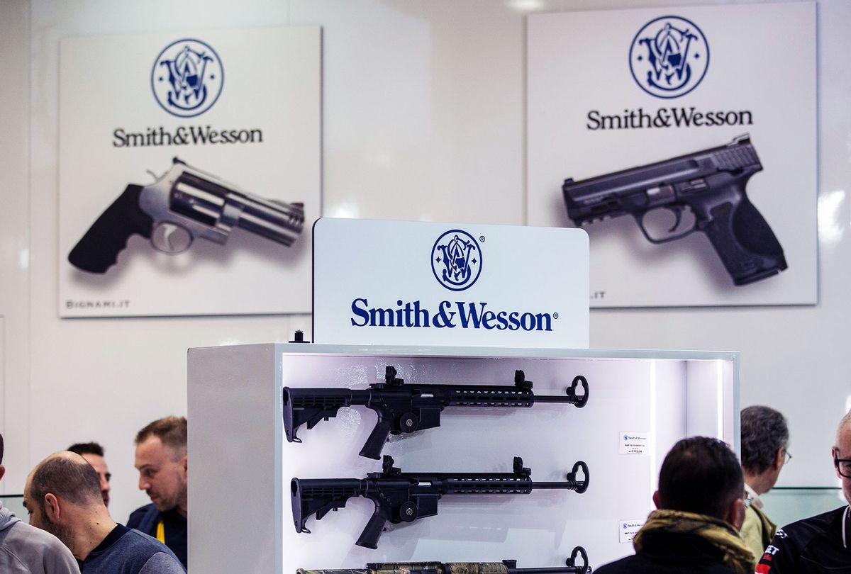 Fairgoers are pictured in front of the Smith & Wesson display stand  (Emanuele Cremaschi/Getty Images)