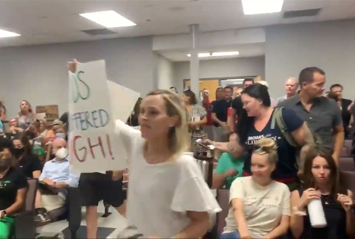 Dozens of enraged anti-mask parents followed an unruly man out in a mob at the Williamson County Schools meeting, Tennessee. (Twitter/@brinleyhineman)