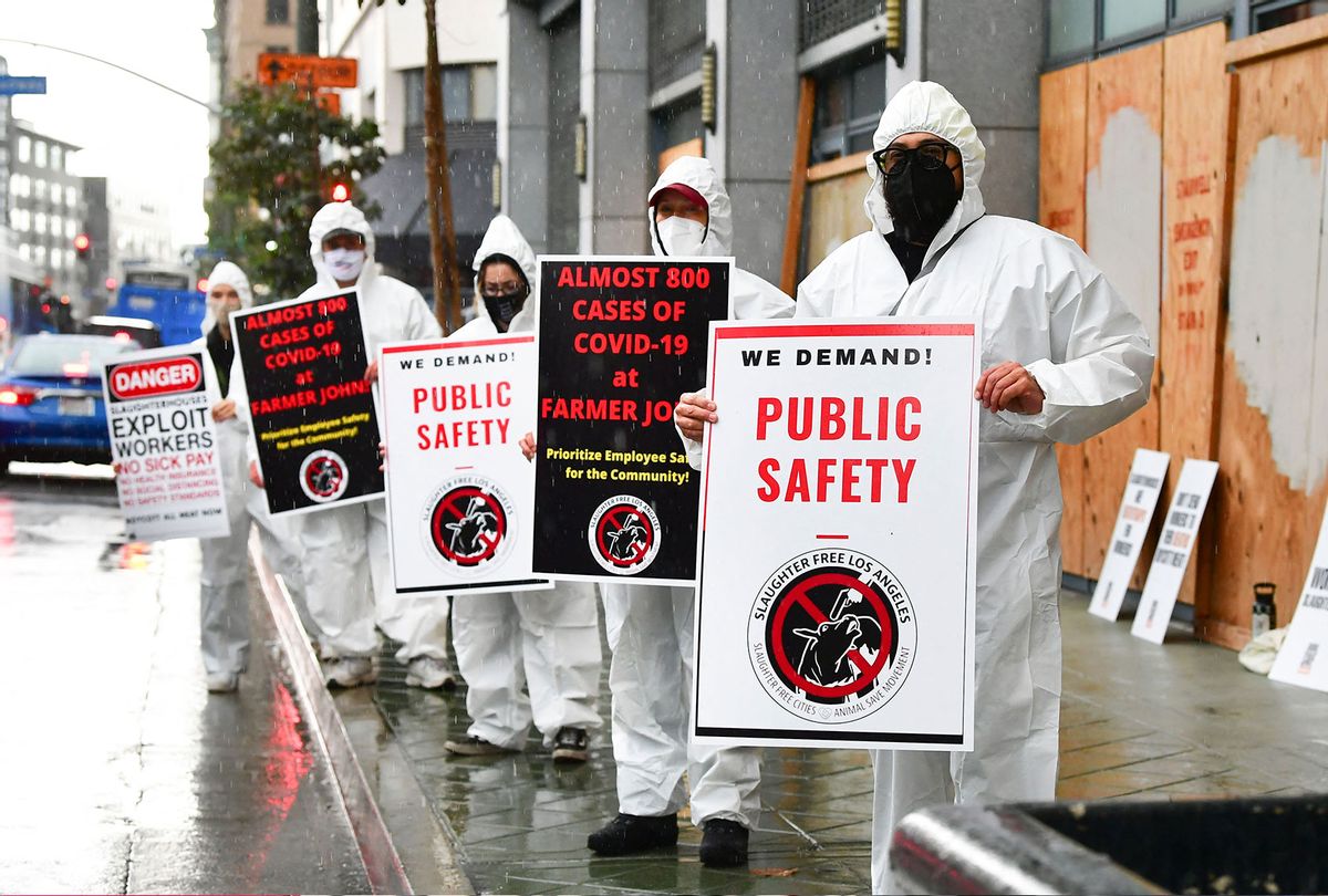 Protesters in front of the Occupational Safety and Health Administration (OSHA) building in Los Angeles, California on March 12, 2021, calling on OSHA to do more to protect workers from Farmer John's slaughterhouse where the total number of Covid-19 positive cases reached 789 as of March 11, totalling almost half the workforce of 1,837 workers. (FREDERIC J. BROWN/AFP via Getty Images)