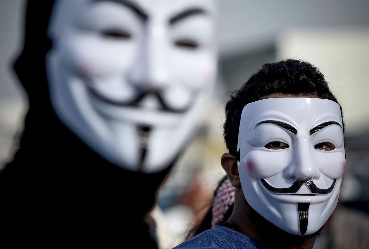 Protesters wearing Guy Fawkes masks used by the Anonymous movement (MOHAMMED AL-SHAIKH/AFP via Getty Images)