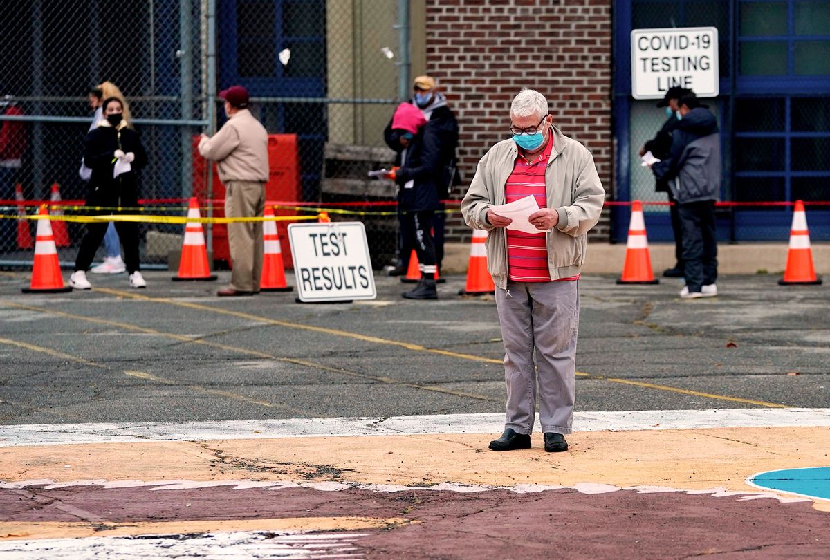 People wait in line to get tested for Covid-19 at the Ann Street School Covid-19 Testing Center in Newark, New Jersey (TIMOTHY A. CLARY/AFP via Getty Images)