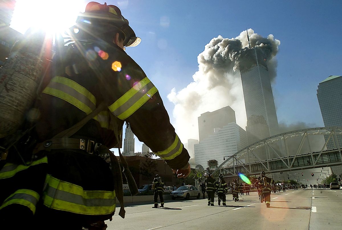 Firefighters walk towards one of the tower at the World Trade Center before it collapsed after a plane hit the building September 11, 2001 in New York City. (Jose Jimenez/Primera Hora/Getty Images)