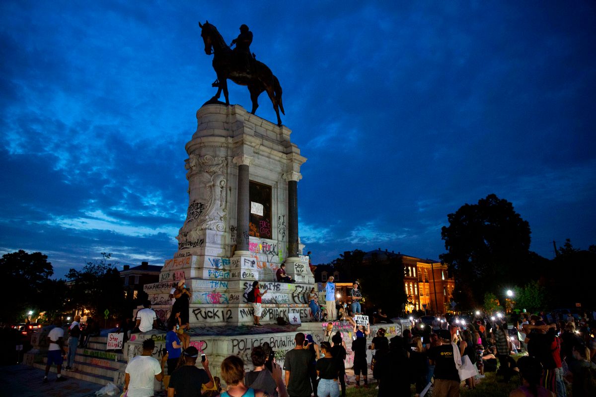 People gather around the Robert E. Lee statue on Monument Avenue in Richmond, Virginia, on June 4, 2020, amid continued protests over the death of George Floyd in police custody. (Ryan M. Kelly/AFP via Getty Images)