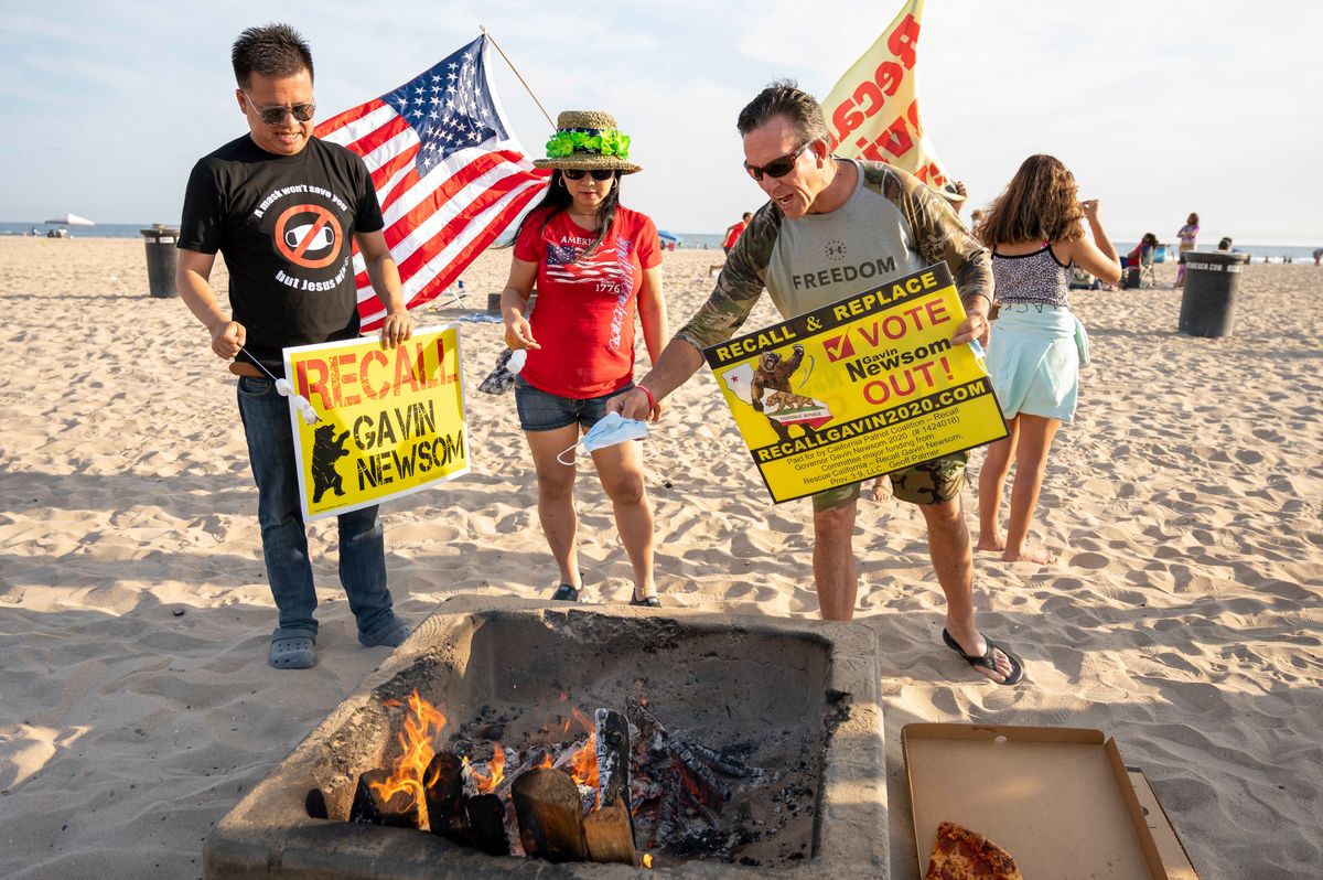 Protesters burn face masks at Huntington City Beach in Huntington Beach, California, on June 15, 2021, as part of a protest against California Gov. Gavin Newsom and the state's mask mandates. (Leonard Ortiz/MediaNews Group/Orange County Register via Getty Images)