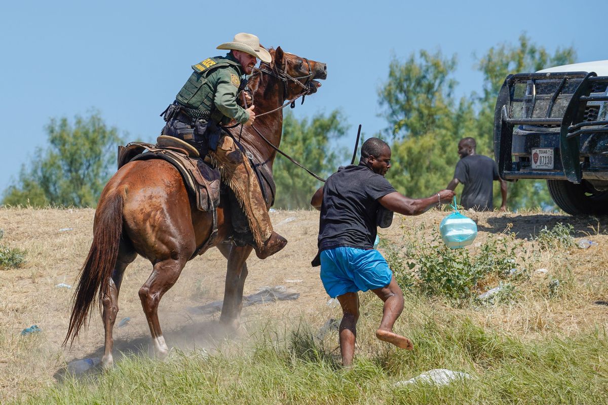 A United States Border Patrol agent on horseback uses the reins to try and stop a Haitian migrant from entering an encampment on the banks of the Rio Grande near the Acuna Del Rio International Bridge in Del Rio, Texas on September 19, 2021.  (PAUL RATJE/AFP via Getty Images)