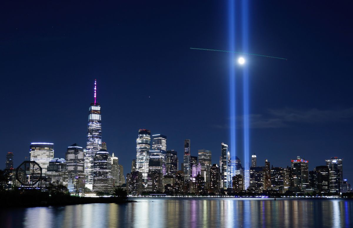 A passing helicopter creates a cross through the beams of the Tribute in Light as it is tested over lower Manhattan and One World Trade Center in New York City. (Gary Hershorn/Getty Images)