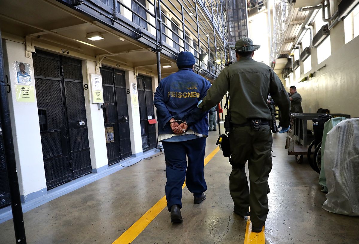An armed California Department of Corrections and Rehabilitation (CDCR) officer escorts a condemned inamte at San Quentin State Prison's death row. (Justin Sullivan/Getty Images)