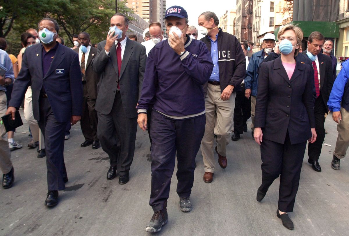 New York City Mayor Rudolph Giuliani (C) leads US Senator Charles Schumer, R-NY (2nd L), New York Governor George Pataki (2nd R) and US Senator Hillary Rodham Clinton, D-NY (R), on a tour of the site of the World Trade Center disaster 12 September 2001 in New York. (ROBERT F. BUKATY/AFP via Getty Images)