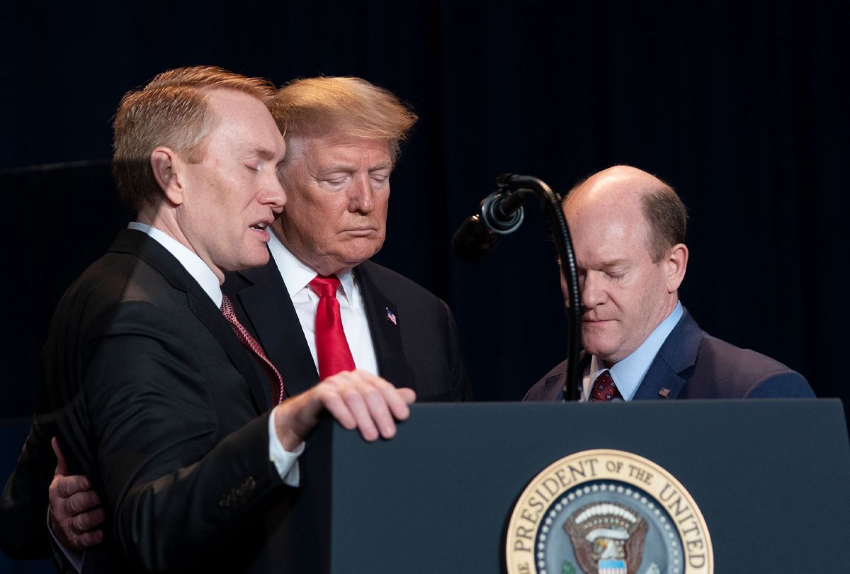 United States Senator James Lankford (Republican of Oklahoma), United States President Donald J. Trump and United States Senator Chris Coons (Democrat of Delaware) pray during the 2019 National Prayer Breakfast on February 7, 2019 in Washington, DC. (Chris Kleponis - Pool/Getty Images)