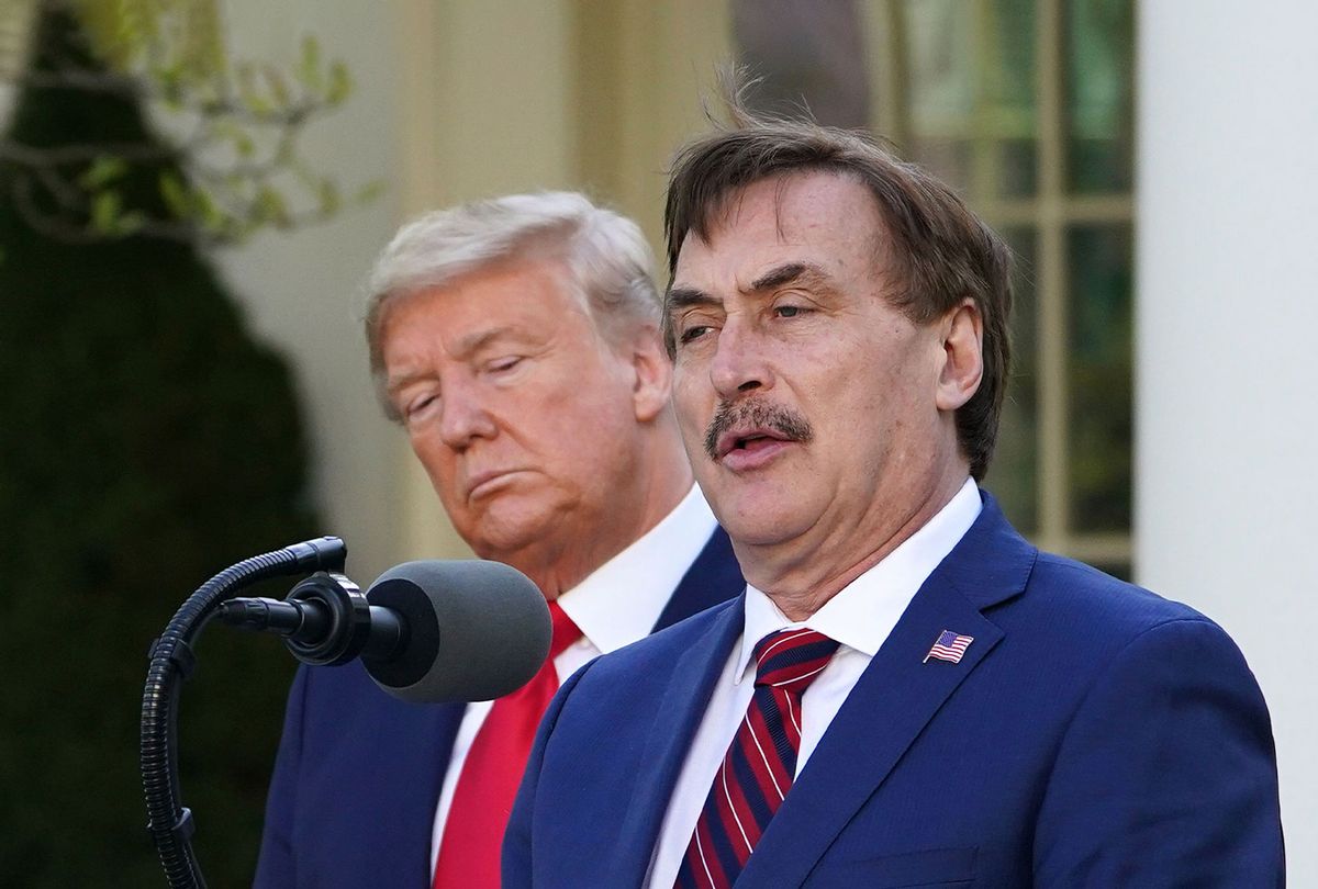 US President Donald Trump listens as Michael J. Lindell, CEO of MyPillow Inc., speaks during the daily briefing on the novel coronavirus, COVID-19, in the Rose Garden of the White House in Washington, DC, on March 30, 2020. (MANDEL NGAN/AFP via Getty Images)