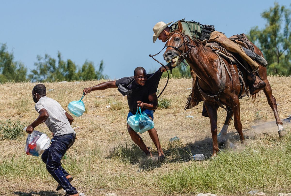 A United States Border Patrol agent on horseback tries to stop a Haitian migrant from entering an encampment on the banks of the Rio Grande near the Acuña Del Rio International Bridge in Del Rio, Texas on September 19, 2021 (Paul Ratje/AFP via Getty Images)