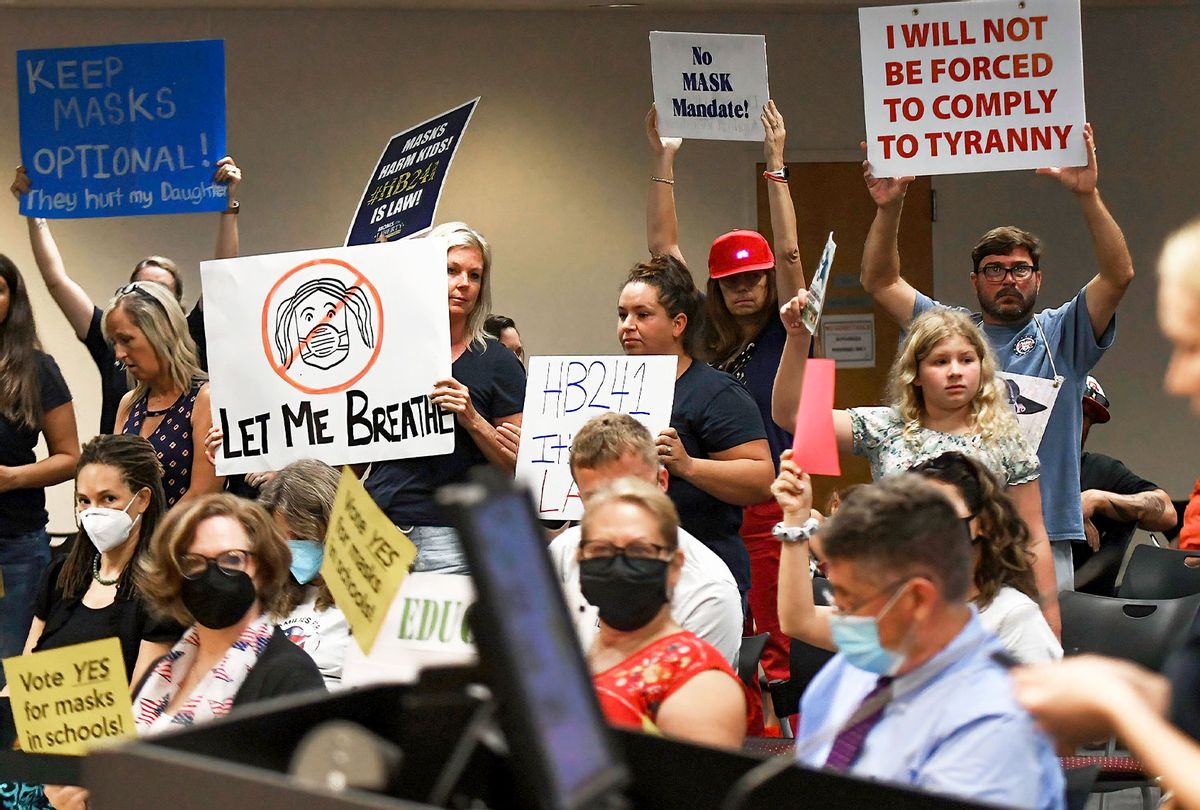 People demonstrate with placards at an emergency meeting of the Brevard County, Florida School Board in Viera to discuss whether face masks in local schools should be mandatory. An executive order signed by Florida Governor Ron DeSantis banning mask mandates in schools was thrown out by a Florida judge on Friday. (Paul Hennessy/SOPA Images/LightRocket via Getty Images)