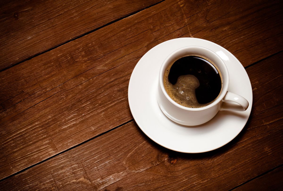 White cup of coffee on old wooden table (Getty Images/Strannik_fox)