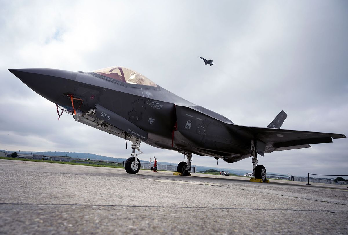 A Lockheed Martin F-35 Lightning II fighter jet is parked on the tarmac at the Payerne Air Base as a Boeing McDonnell Douglas F/A-18 Hornet takes off in the background, during flight and ground tests, as Switzerland is looking for a new fighter jet to replace its aging fleet, on June 7, 2019 in Payerne. (FABRICE COFFRINI/AFP via Getty Images)