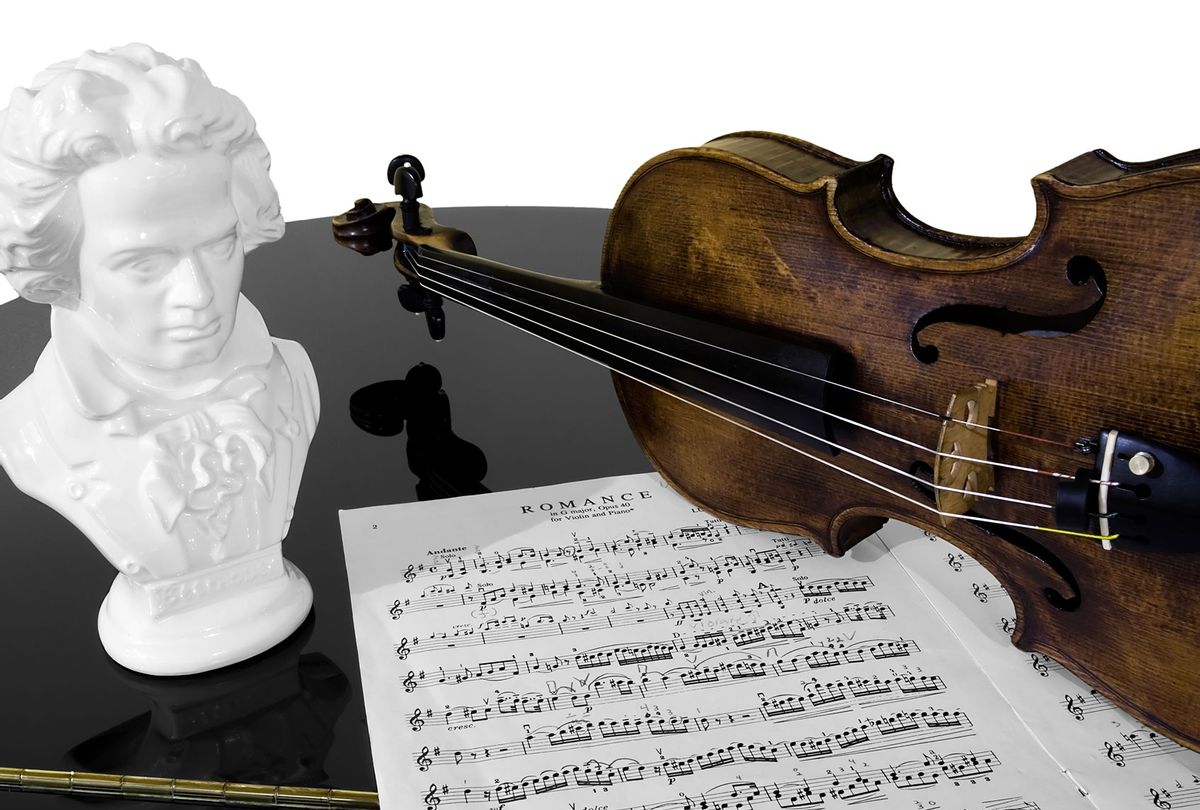 A violin, score, and bust of Beethoven atop a piano, isolated against a white background (Getty Images/davidcrehner)