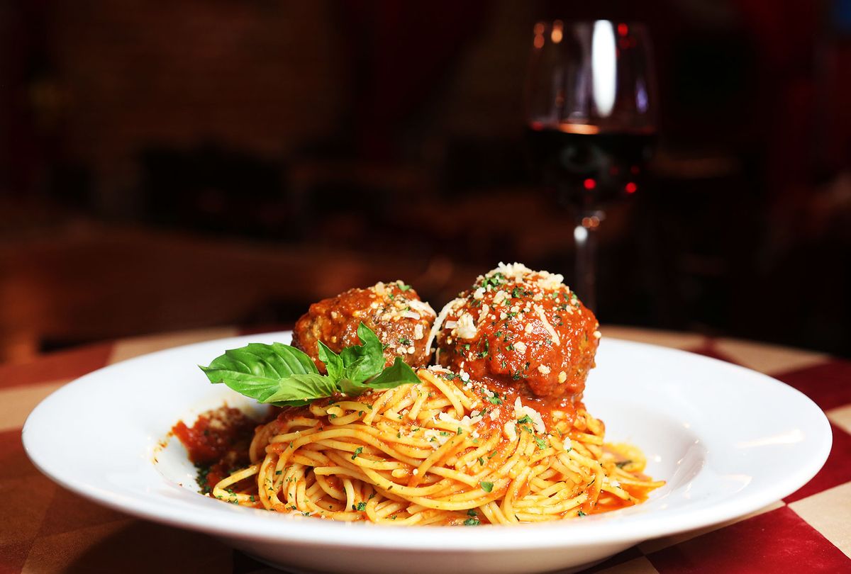 Spaghetti and meatballs served with red wine at a restaurant (Getty Images/Marianna Massey)