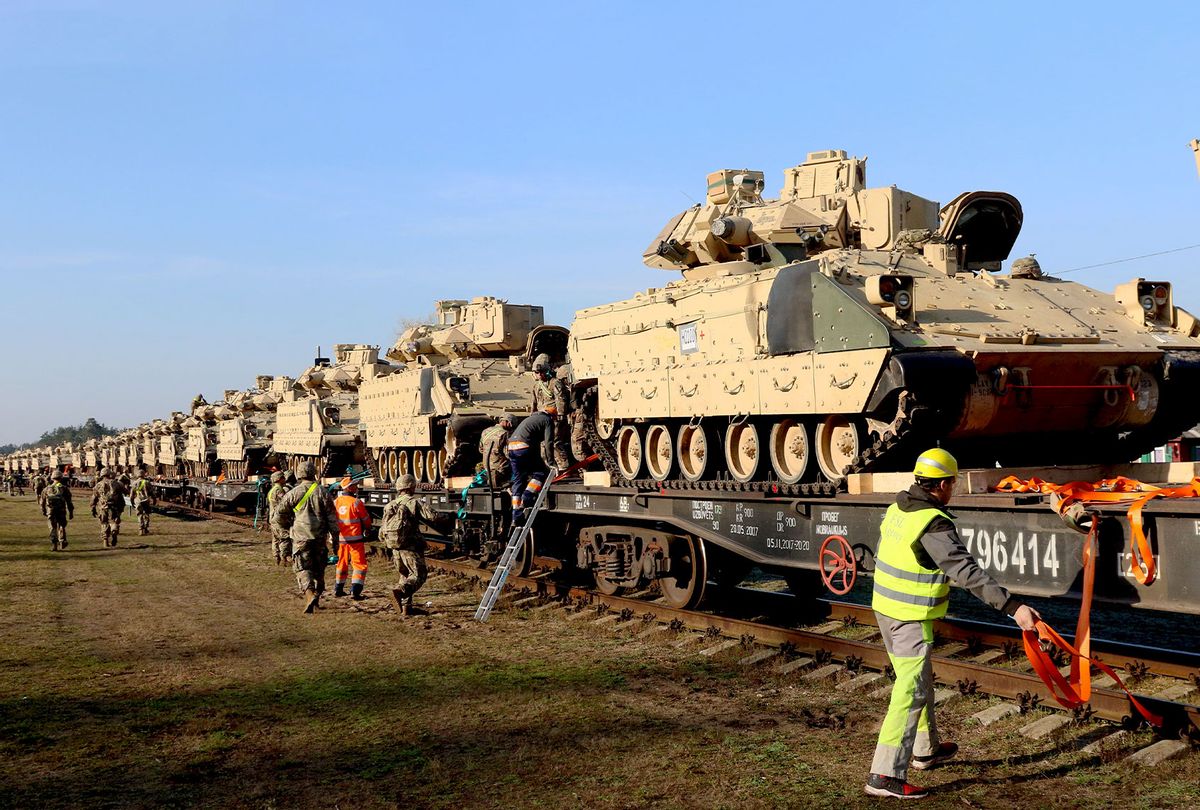 Members of the US Army 1st Division 9th Regiment 1st Battalion unload heavy combat equipment including Abrams tanks and Bradley fighting vehicles at the railway station near the Pabrade military base in Lithuania, on October 21, 2019. (PETRAS MALUKAS/AFP via Getty Images)