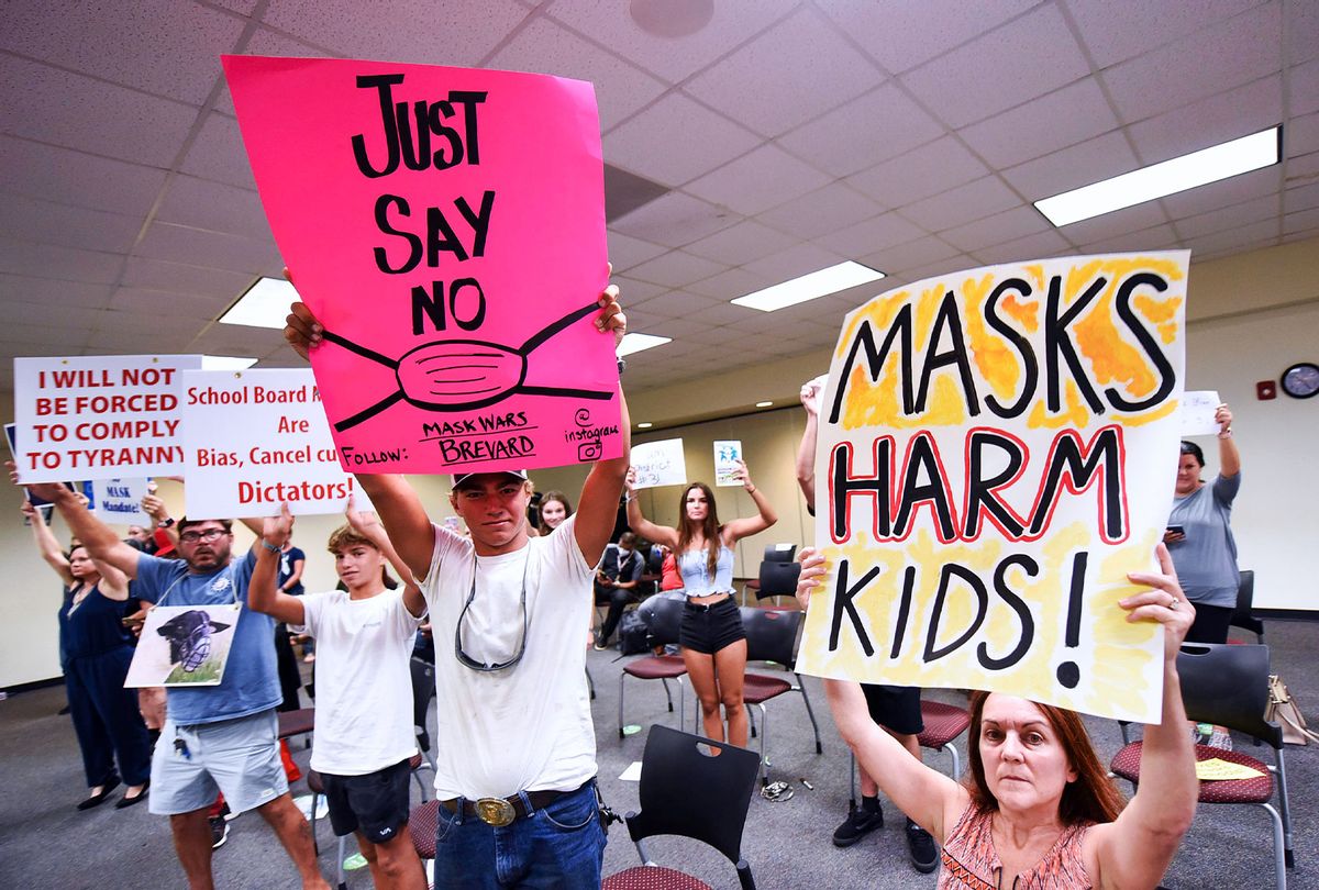 People demonstrate with placards at an emergency meeting of the Brevard County, Florida School Board in Viera to discuss whether face masks in local schools should be mandatory. An executive order signed by Florida Governor Ron DeSantis banning mask mandates in schools was thrown out by a Florida judge on Friday. (Paul Hennessy/SOPA Images/LightRocket via Getty Images)