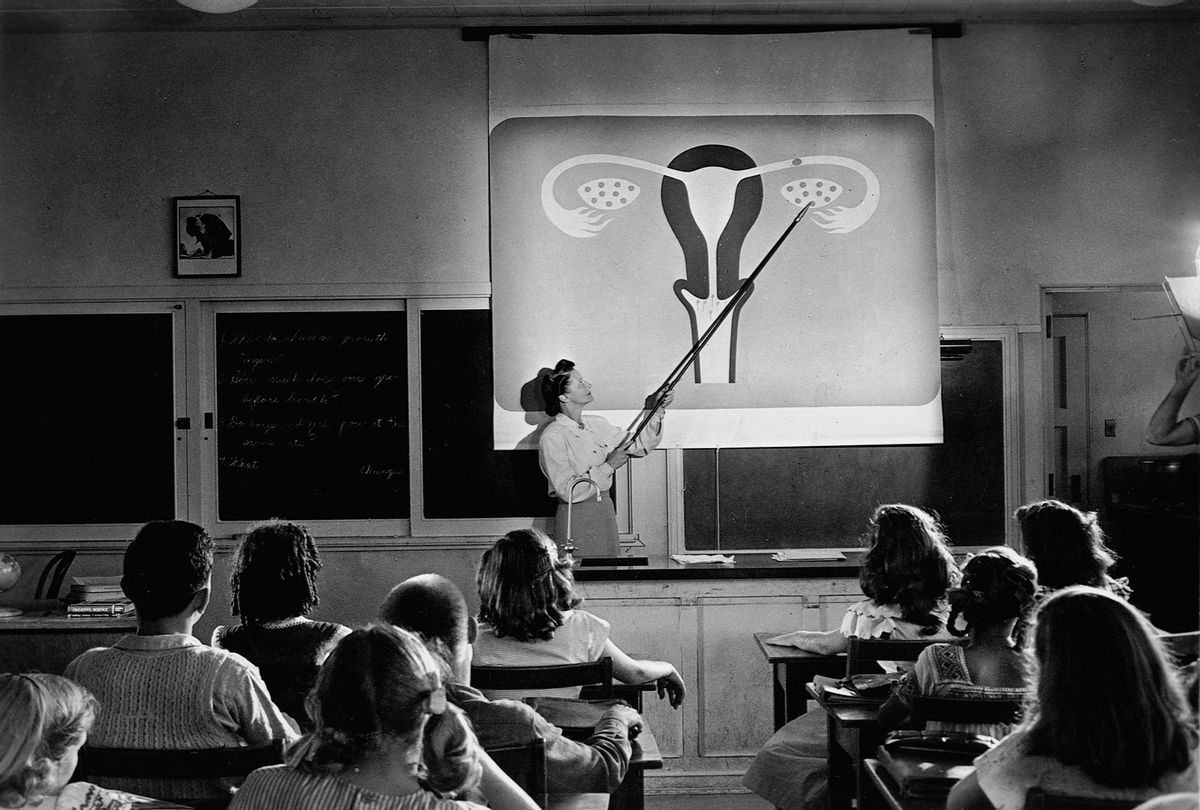 A teacher points to a diagram of female reproductive organs projected on a screen in a classroom in a scene from Human Growth, an education film on sex education shown to students in Oregon junior high schools beginning in 1948. (Library of Congress/Corbis/VCG via Getty Images)