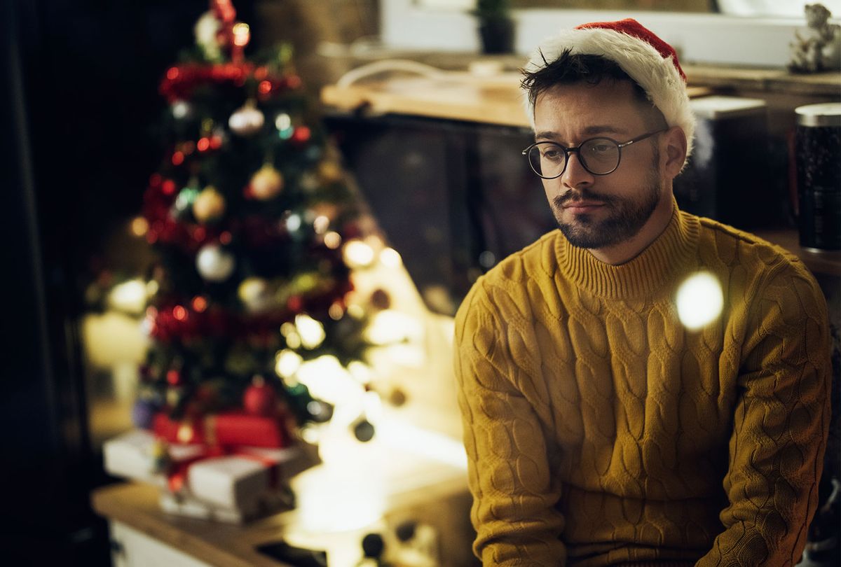 Young sad man spending Christmas Eve alone at home (Getty Images/Drazen Zigic)