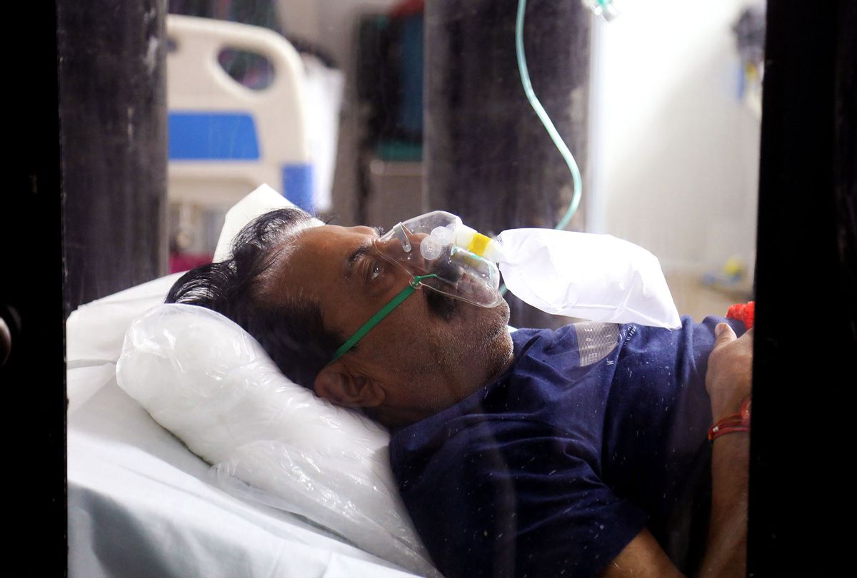 A Covid-19 infected patient receiving medical oxygen for breathing comfortably seen inside a Covid care center of the Commonwealth Games (CWG) villages temporarily converted into a Covid-19 care facility. (Naveen Sharma/SOPA Images/LightRocket via Getty Images)