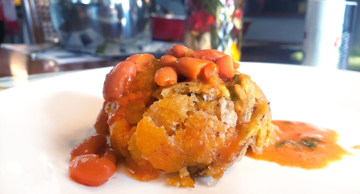Mofongo, made from fried mashed green plantains with garlic. salt and pepper mixed with pork cracklings, then shaped into a ball. Served with red beans. (Getty Images)