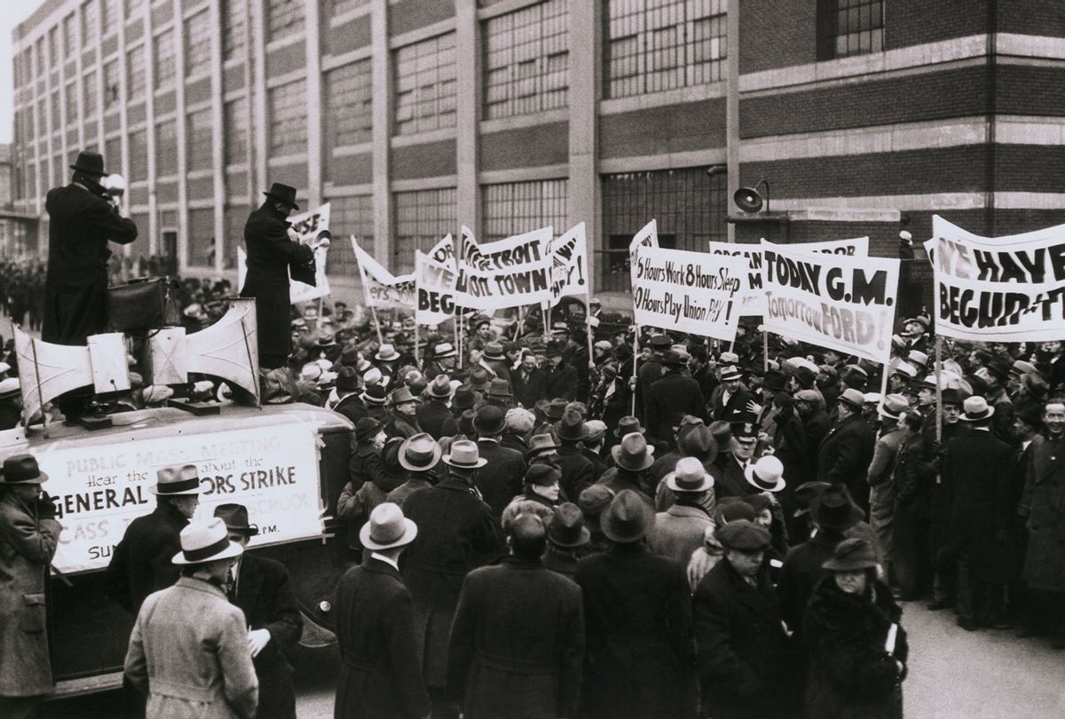 Sit Downers Hail "Armistice Day." Sit down strikers at the Cadillac and Fleetwood Plants here, led by a hand playing "Hail to the Victors" march jubilantly from the plants after a truce had been declared permitting negotiation between G. M. officials and members of the United Automobile workers of America. General Motors is determined however not to surrender exclusive collective bargaining rights for employees to the United Automobile workers (Getty Images/Bettmann/Contributor)