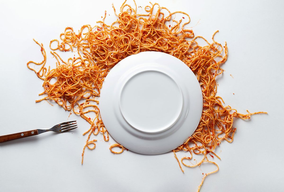 A fallen white ceramic plate of spaghetti, with a fork beside it (Getty Images/Aleksandr Zubkov)