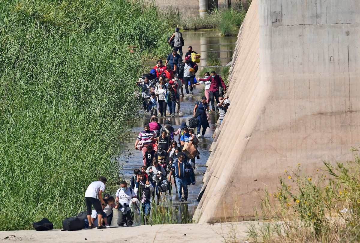 Migrants attempt to cross in to the U.S. from Mexico at the border October 10, 2021 in San Luis, Arizona. (Nick Ut/Getty Images)