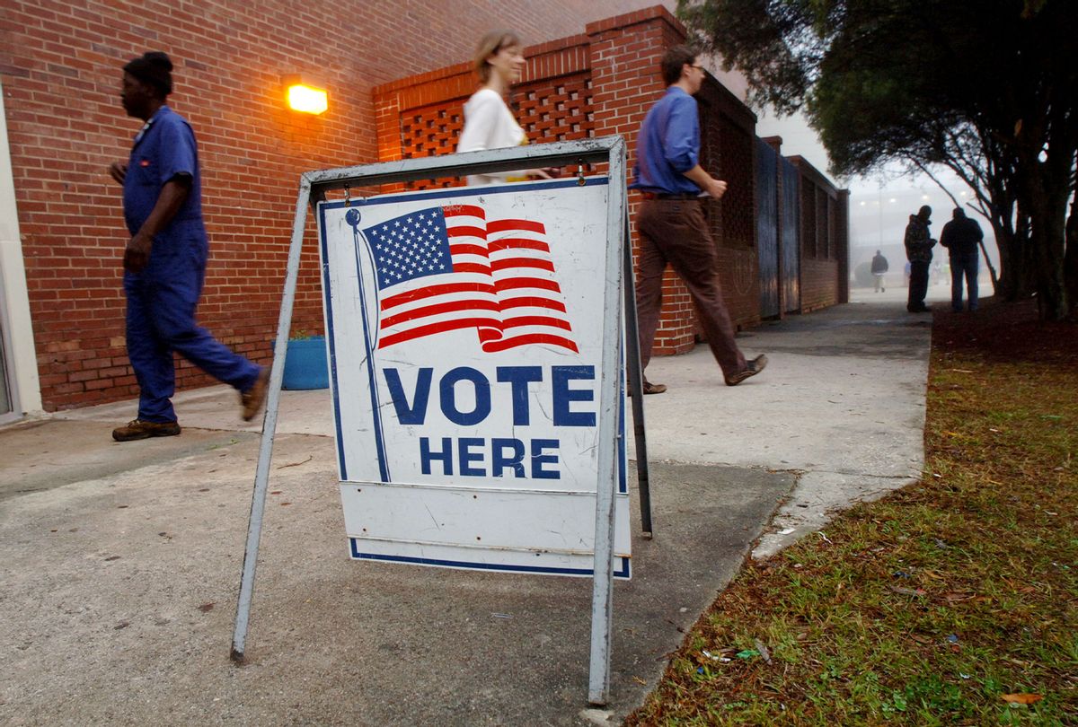 Vote here sign in front of an election site. (Stephen Morton/Getty Images)