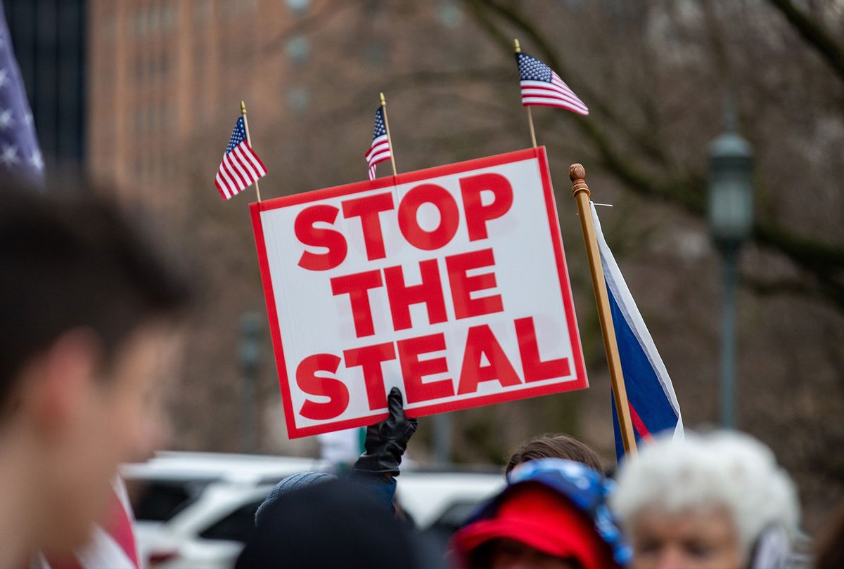 A protester holds a "stop the steal" placard during a pro-Trump demonstration.  (Paul Weaver/SOPA Images/LightRocket via Getty Images)