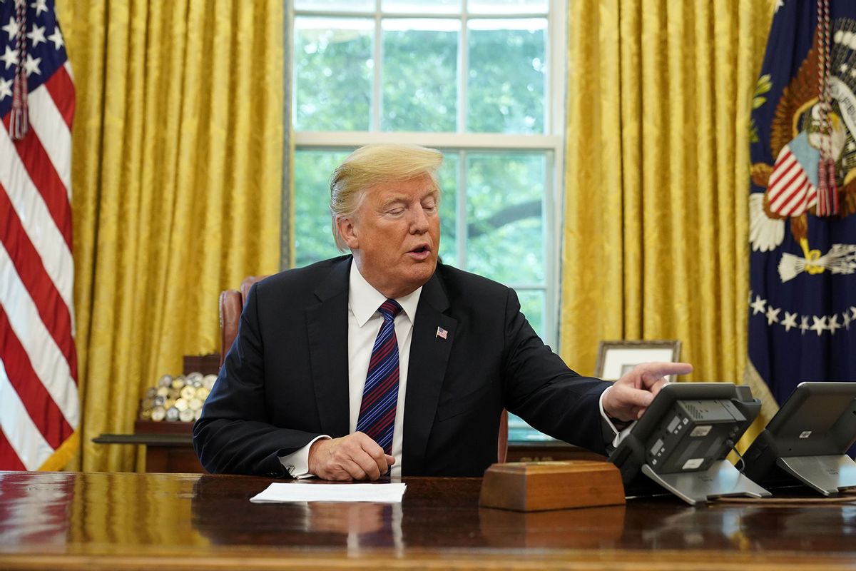 US President Donald Trump looks at his telephone from the Oval Office at the White House on August 27, 2018 in Washington, DC. (MANDEL NGAN/AFP via Getty Images)