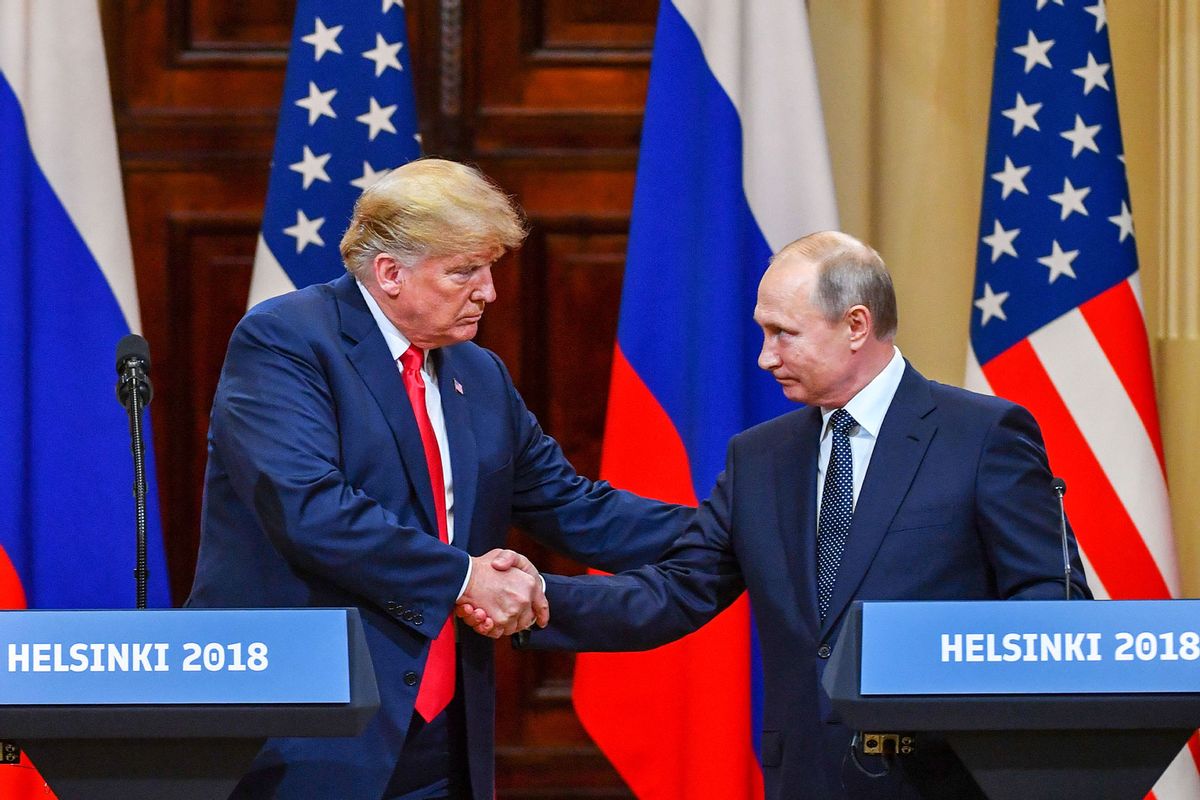 US President Donald Trump (L) and Russia's President Vladimir Putin shake hands before attending a joint press conference after a meeting at the Presidential Palace in Helsinki, on July 16, 2018. (YURI KADOBNOV/AFP via Getty Images)