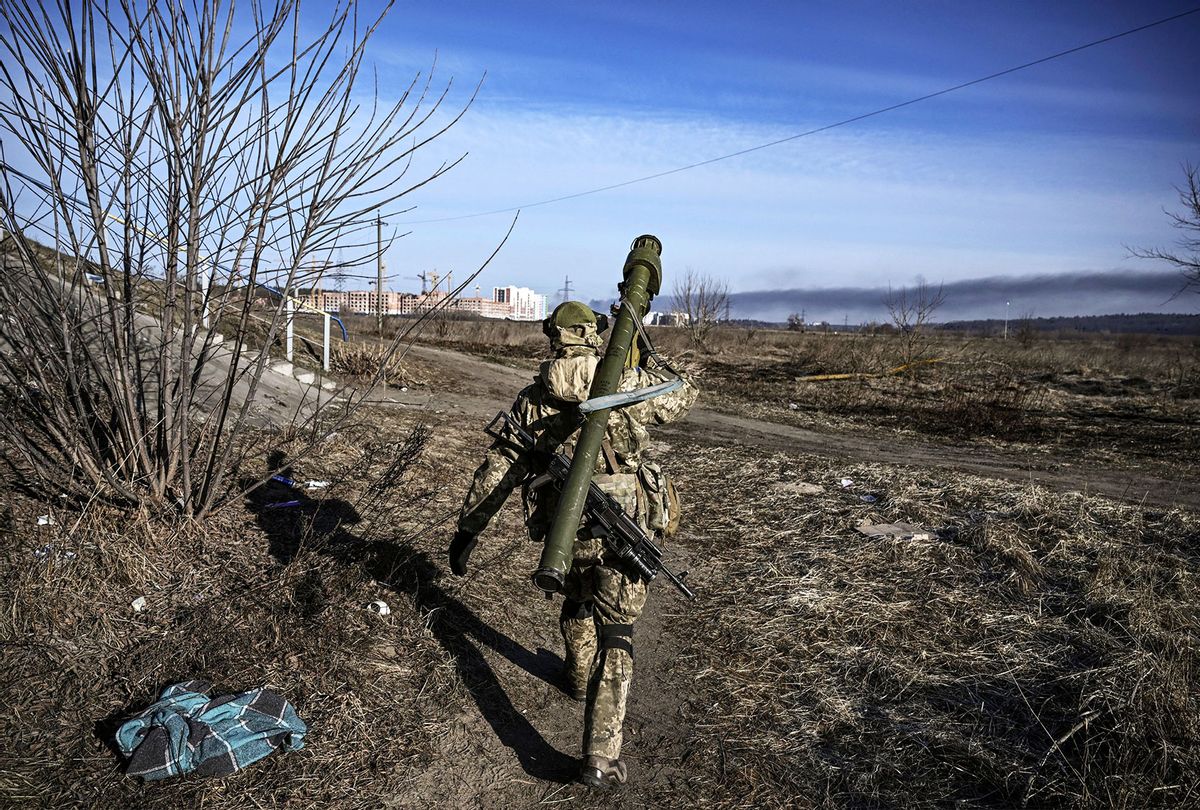 A Ukrainian serviceman walks towards the front line in the city of Irpin, northern Ukraine, on March 12, 2022. - Russian forces are positioned around Kiev on March 12, 2022 and are "blocking" Mariupol, where thousands of people are suffering a devastating siege, in southern Ukraine, a country that has been bombed for more than two weeks. (ARIS MESSINIS/AFP via Getty Images)