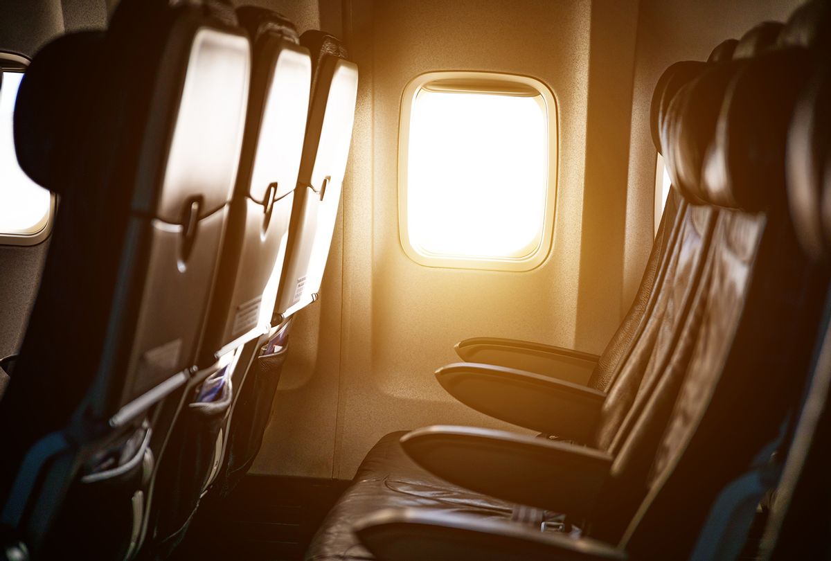Empty airplane seats in the cabin in sunset light (Getty Images / Anton Petrus)