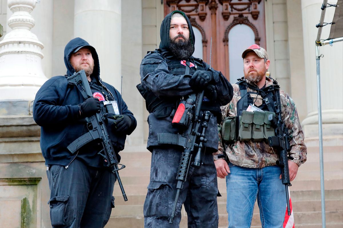 Armed protesters provide security as demonstrators take part in an "American Patriot Rally," organized on April 30, 2020, by Michigan United for Liberty on the steps of the Michigan State Capitol in Lansing, demanding the reopening of businesses. - Michigan's stay-at-home order declared by Democratic Governor Gretchen Whitmer is set to expire after May 15. (JEFF KOWALSKY/AFP via Getty Images)