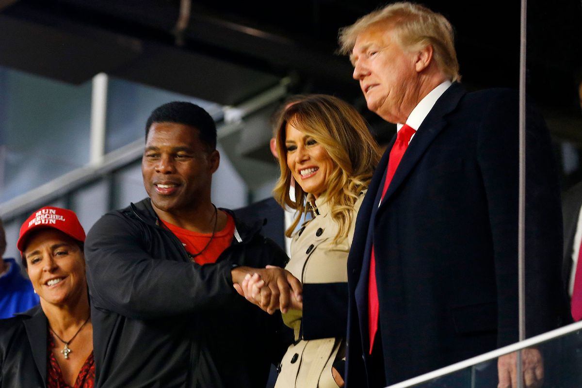 Former football player and political candidate Herschel Walker interacts with former president of the United States Donald Trump prior to Game Four of the World Series between the Houston Astros and the Atlanta Braves Truist Park on October 30, 2021 in Atlanta, Georgia. (Michael Zarrilli/Getty Images)