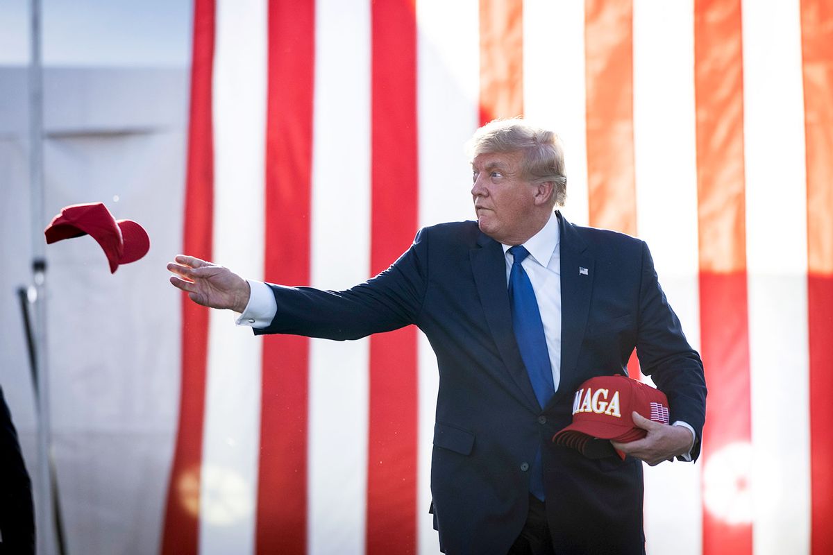 Former U.S. President Donald Trump tosses hats to the crowd as he arrives during a rally hosted by the former president at the Delaware County Fairgrounds on April 23, 2022 in Delaware, Ohio. (Drew Angerer/Getty Images)