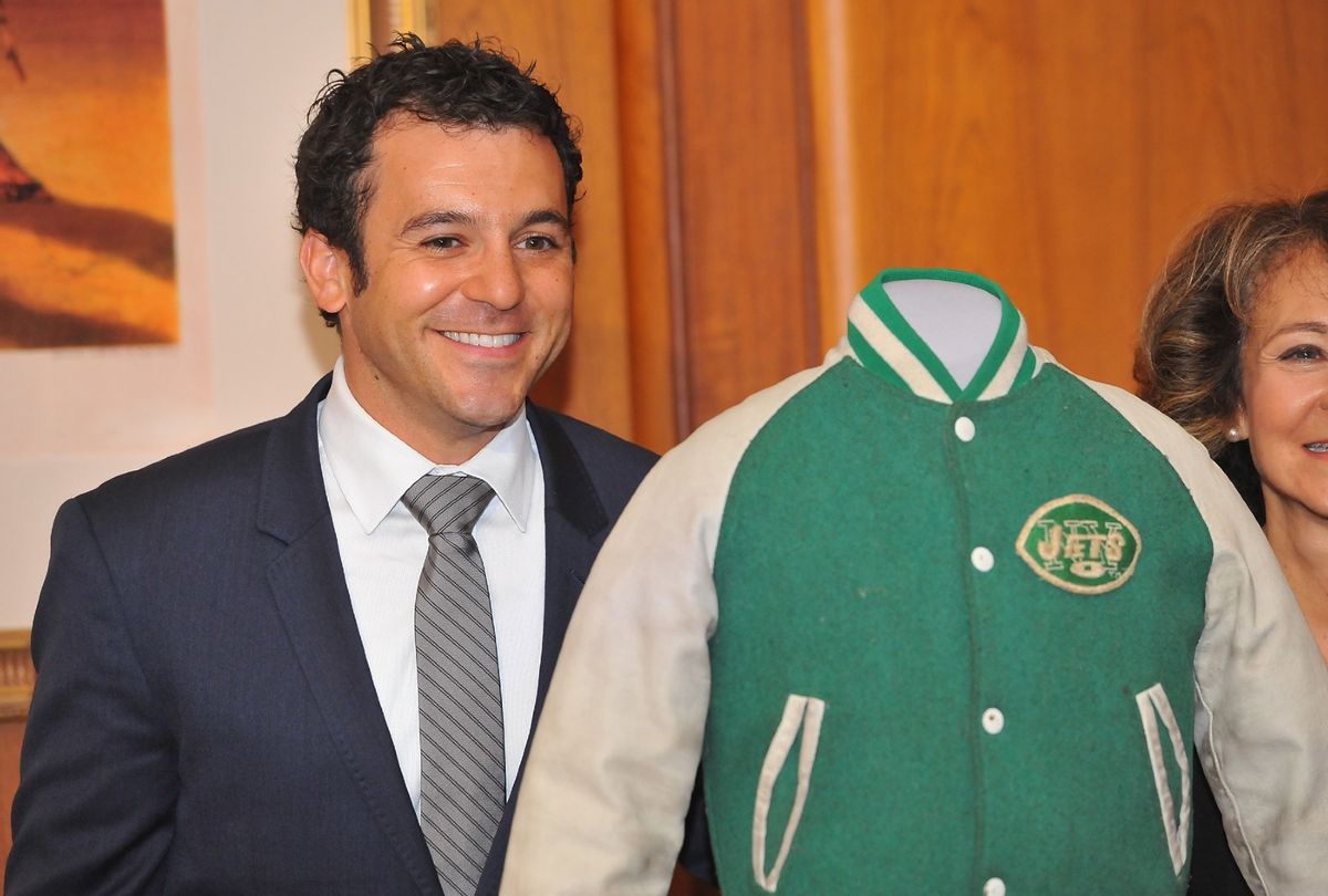 Fred Savage poses with the iconic NY Jets jacket he wore in the TV series "The Wonder Years" after donating it to the National Museum Of American History on December 2, 2014 in Washington, DC. (Larry French/Getty Images)