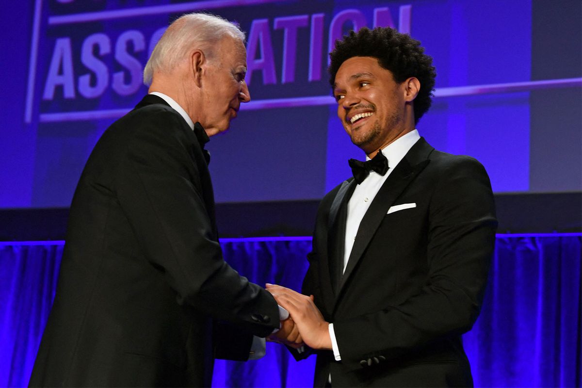 US President Joe Biden (L) shakes hands with South African comedian Trevor Noah during the White House Correspondents Association gala at the Washington Hilton Hotel in Washington, DC, on April 30, 2022. (NICHOLAS KAMM/AFP via Getty Images)