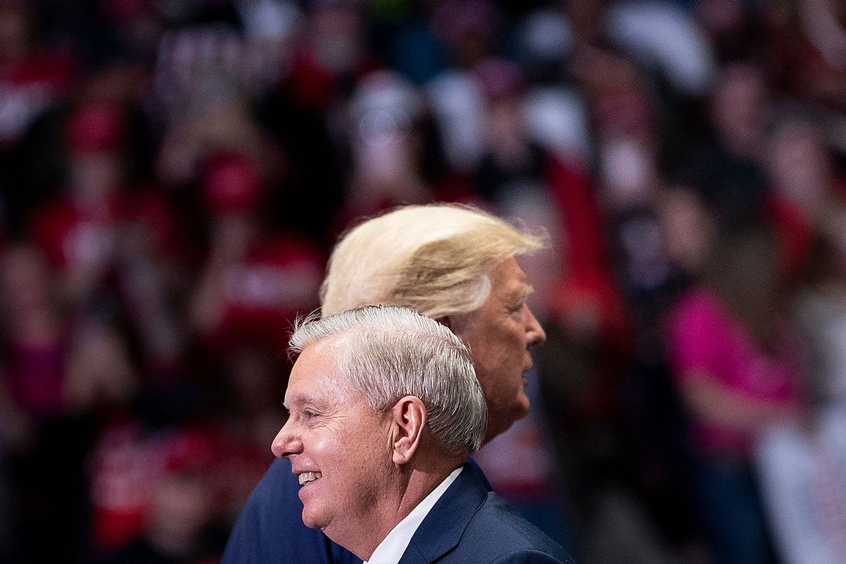 Senator Lindsey Graham (R-SC) arrives to speak with US President Donald Trump (R) during a rally at Bojangles' Coliseum on March 2, 2020, in Charlotte, North Carolina. (Photo by BRENDAN SMIALOWSKI/AFP via Getty Images)