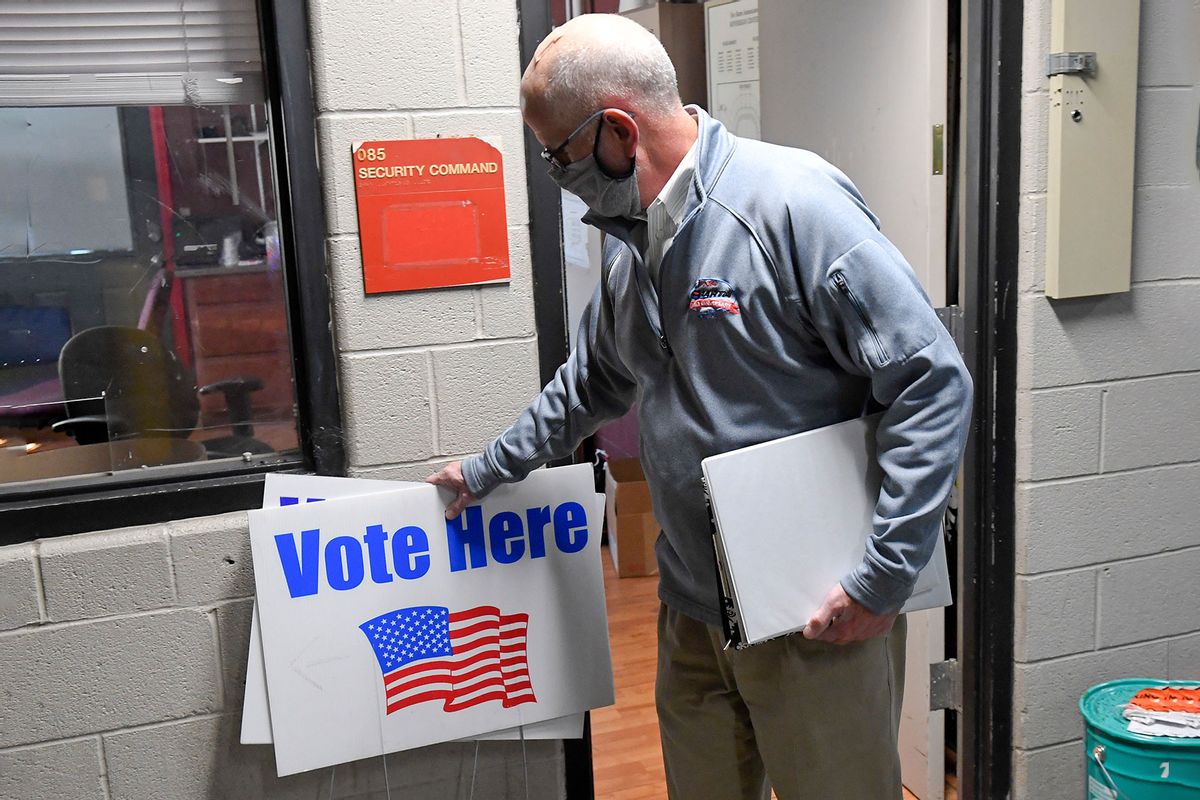 Berks County, PA official setting up "Vote Here" signs in preparation for election day. (Ben Hasty/MediaNews Group/Reading Eagle via Getty Images)