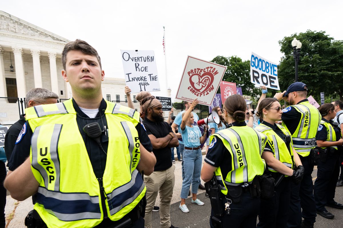 U.S. Capitol Police officers form a line to separate pro-choice and pro-life activists outside the U.S. Supreme Court, June 21, 2022. (Bill Clark/CQ-Roll Call, Inc via Getty Images)