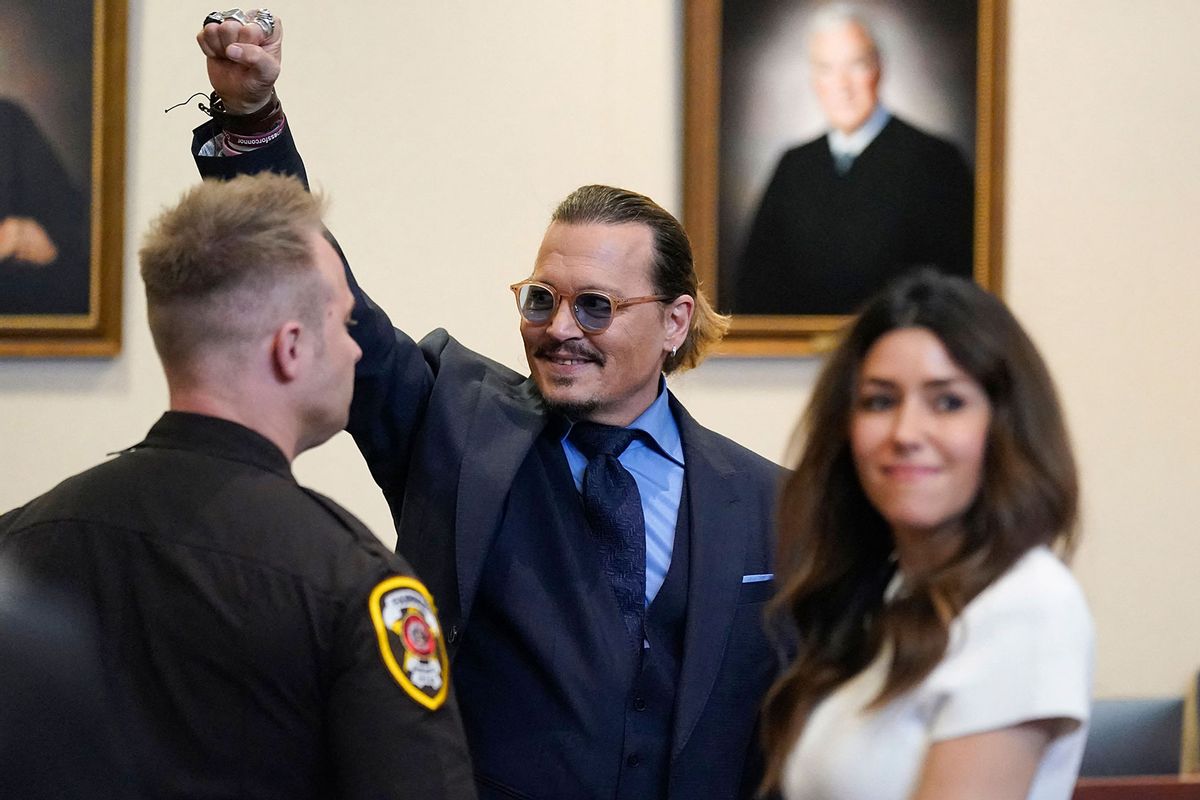 Actor Johnny Depp gestures to spectators in court after closing arguments at the Fairfax County Circuit Courthouse in Fairfax, Virginia, on May 27, 2022. (STEVE HELBER/POOL/AFP via Getty Images)