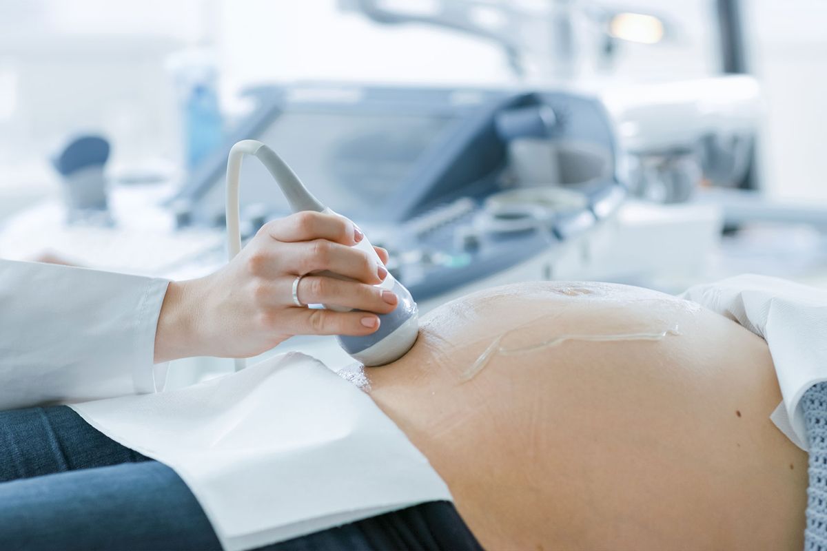 Doctor Doing Ultrasound / Sonogram Scan to a Pregnant Woman (Getty Images/gorodenkoff)