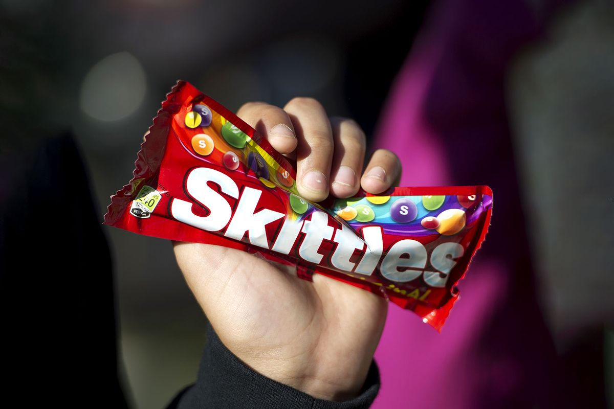 Hand holding a bag of Skittles candies (ROBYN BECK/AFP via Getty Images)
