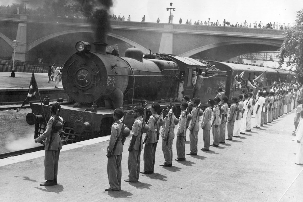 One of 30 special trains leaving New Delhi Station which will take the staff of the Pakistan government to Karachi. Muslim League National Guards stand to attention in honour of the departure. (Keystone Features/Getty Images)