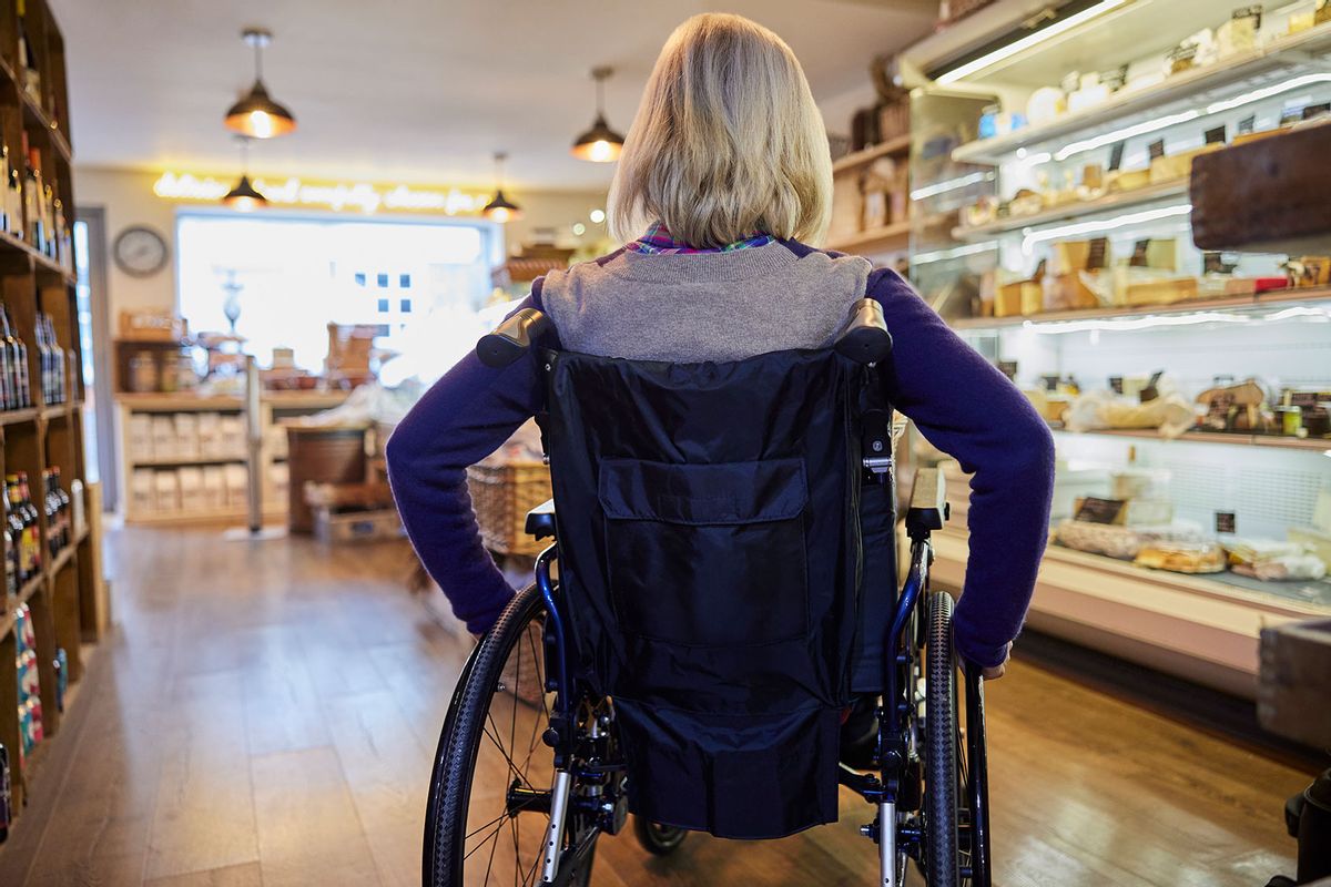Rear View Of Woman In Wheelchair Shopping For Food (Getty Images/Daisy-Daisy)