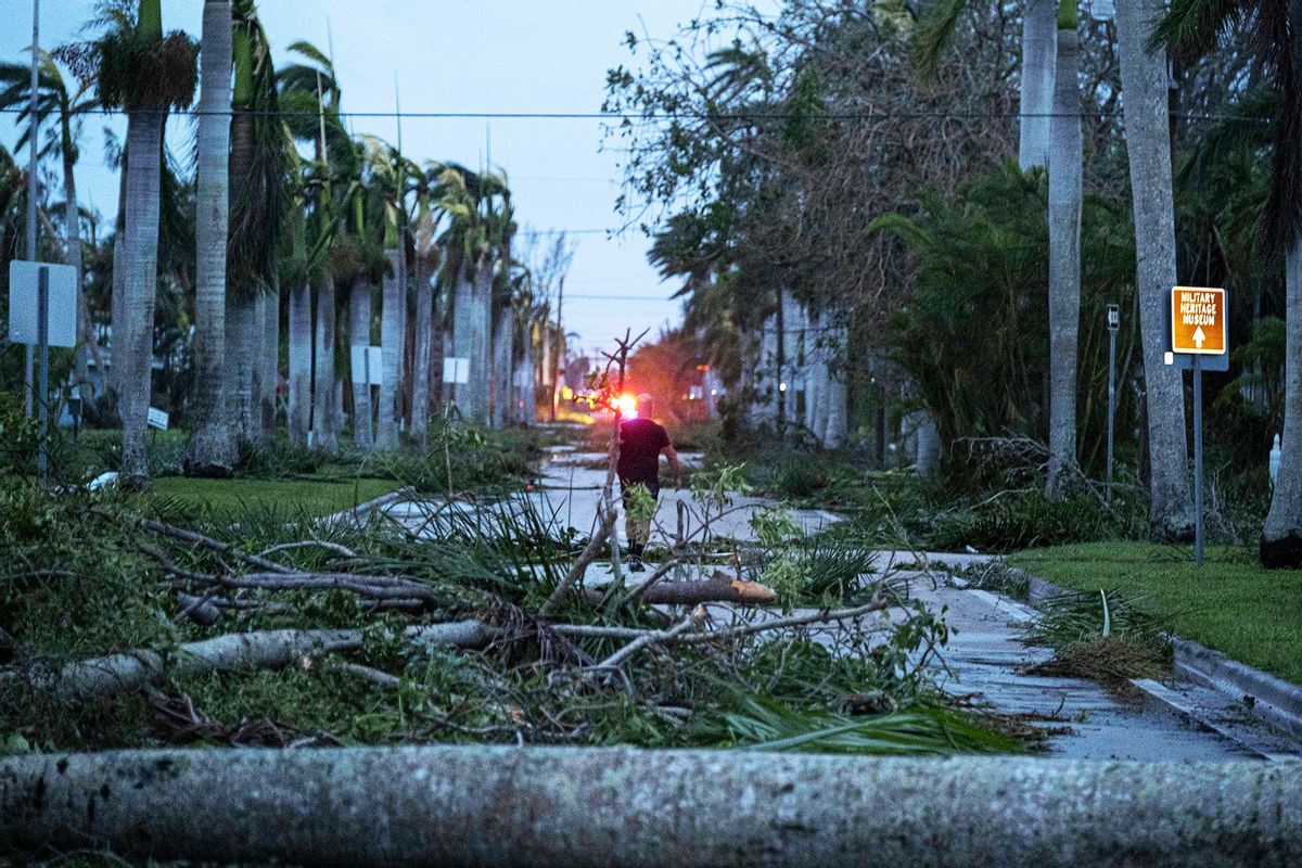 A man walks through debris on a street in the aftermath of Hurricane Ian in Punta Gorda, Florida on September 29, 2022. (RICARDO ARDUENGO/AFP via Getty Images)